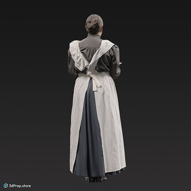 3D scan of a standing, middle-aged maid, wearing a white apron and a grey long-sleeved dress underneath, and she is holding a silver serving tray, from the 1910s, Europe. 
Probably a noble family's maid.