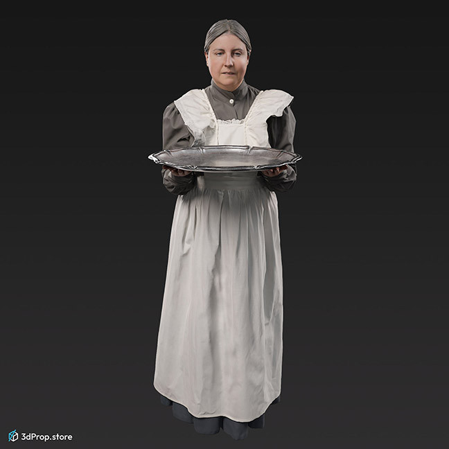 3D scan of a standing, middle-aged maid, wearing a white apron and a grey long-sleeved dress underneath, and she is holding a silver serving tray, from the 1910s, Europe. 
Probably a noble family's maid.